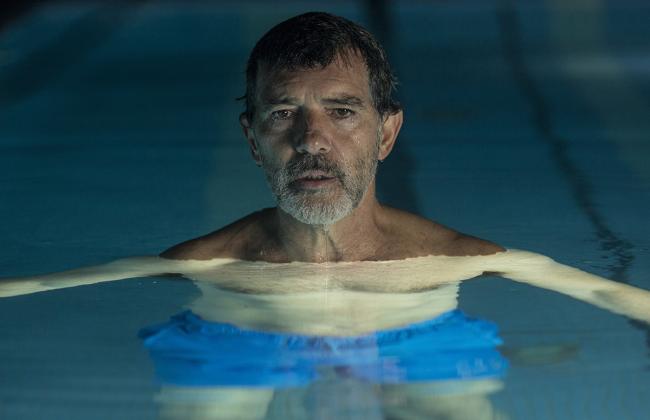 Actor Antonio Banderas floats in a swimming pool with his head above the surface of the water
