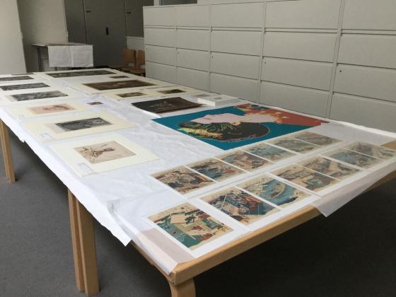 Art laid out for a Five Tables viewing at BAMPFA