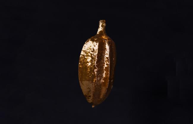 Erica Deeman's artwork [murmur], a copper-hued metallic object in a shape resembling a cacao bean pod.